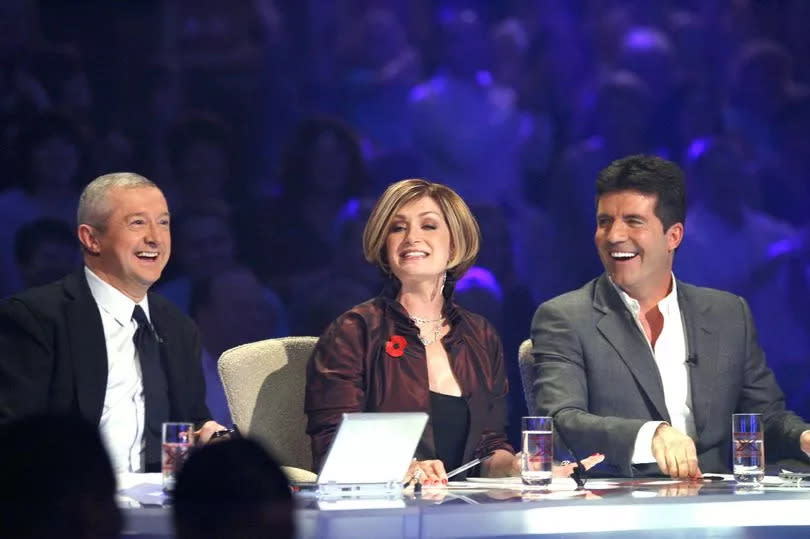 Simon sits with Sharon and Louis on the XFactor