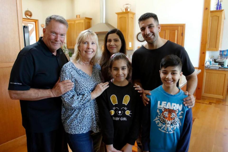 Mike Reeves and his wife, Linda Giordano, far left, pose for a picture with Negina Barakazai, her husband Kawa Barakazai and their children Maryam and son Ben Yamin in their new Cambria home. The Barakazai family spent more than two years in hiding in Afghanistan and Pakistan before arriving in the United States on Sept. 6, 2023, with help from Reeves, Giordano and others.