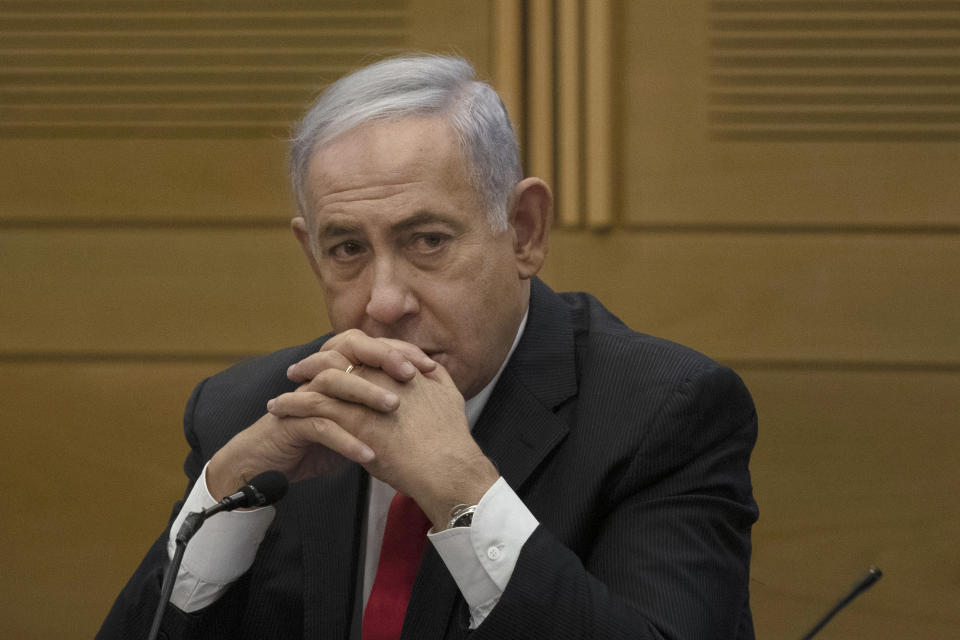 FILE - Former Israeli Prime Minister Benjamin Netanyahu speaks to right-wing opposition party members, at the Knesset, Israel's parliament, in Jerusalem on June 14, 2021. Netanyahu watched from the sidelines Thursday as the government that toppled him after 12 years in power passed a national budget, dealing a major blow to his hopes of a swift return to the country's top office. (AP Photo/Maya Alleruzzo, File)