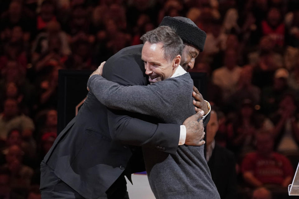 Former Phoenix Suns' Steve Nash, front right, hugs former teammate Amare Stoudemire during Stoudemire's Ring of Honor ceremony during halftime o an NBA basketball game between the Suns and the Houston Rockets in Phoenix, Saturday, March. 2, 2024. (AP Photo/Darryl Webb)