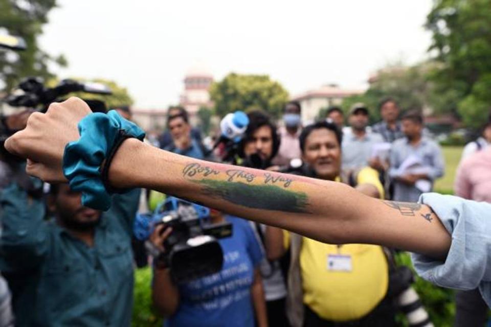 An activist displays a tattoo reading ‘Born this way’ in the courtyard of India’s Supreme Court in New Delhi on 17 October 2023 (Sajjad HUSSAIN/AFP via Getty)