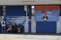 FILE - Workers rest near billboard showing Chinese President Xi Jinping, reading: "Welcome President," right, and billboard reading: "Nobody was hurt in my shift today," in front of the Zelezara Smederevo steel mill, in the city of Smederevo, 45 kilometers east of Belgrade, Serbia, on June 29, 2017. Chinese leader Xi Jinping's visit to European ally Serbia on Tuesday, May 7, 2024, falls on a symbolic date: the 25th anniversary of the bombing of the Chinese Embassy in Belgrade during NATO's air war over Kosovo. (AP Photo/Darko Vojinovic, File)