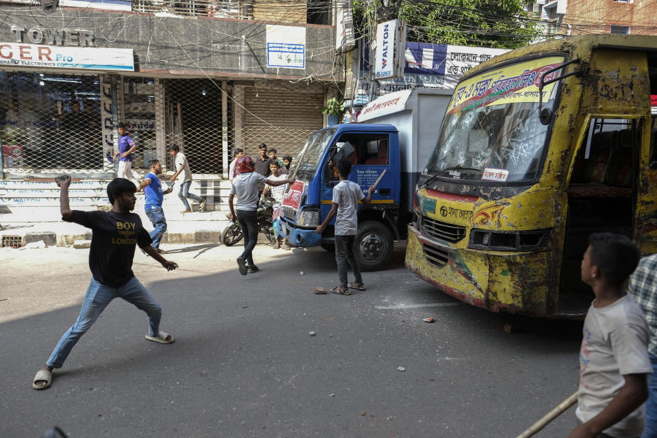 Bangladeshi garment workers vandalize buses during a protest demanding an increase in their wages at Mirpur in Dhaka, Bangladesh, Tuesday, Oct.31, 2023. (AP Photo/Mahmud Hossain Opu)