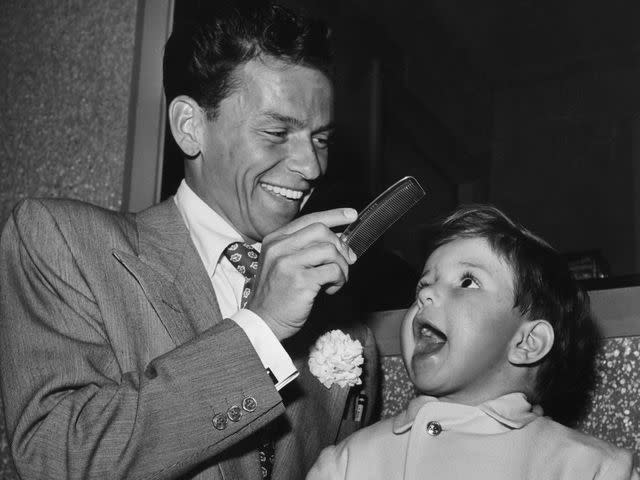 <p>Hulton Archive/Getty </p> Frank Sinatra and Frank Jr. on the set of 'It Happened in Brooklyn'.