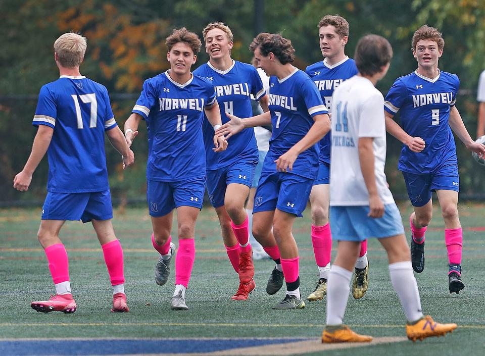 Norwell captain Max Flanders gets props from teammates after scoring in the first half.Norwell boys soccer hosted East Bridgewater onMonday October 17, 2022.