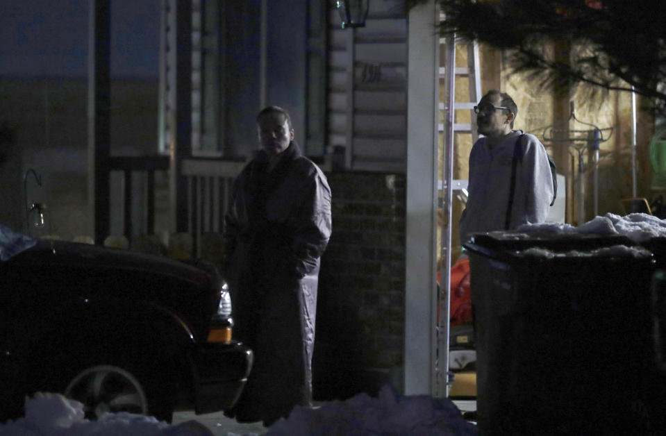 Neighbors watch as law enforcement officials work at a nearby Enoch, Utah, home where eight members of a family were found dead from gunshot wounds, Wednesday, Jan. 4, 2023. (Ben B. Braun/The Deseret News via AP)