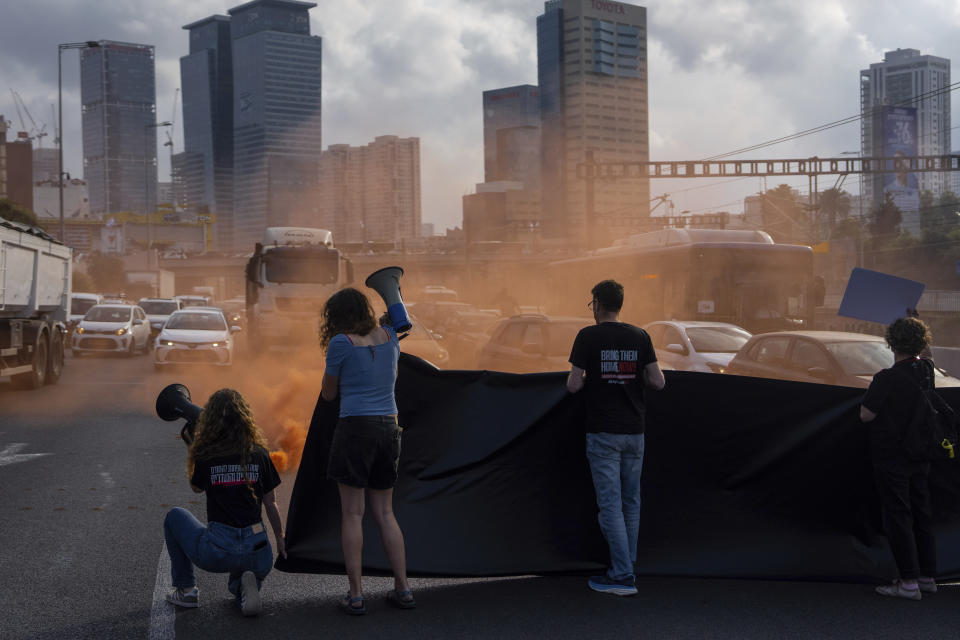 Activists block a highway as they demand the release of the hostages from Hamas captivity in the Gaza Strip, in Tel Aviv, Israel, Thursday, May 2, 2024. (AP Photo/Oded Balilty)