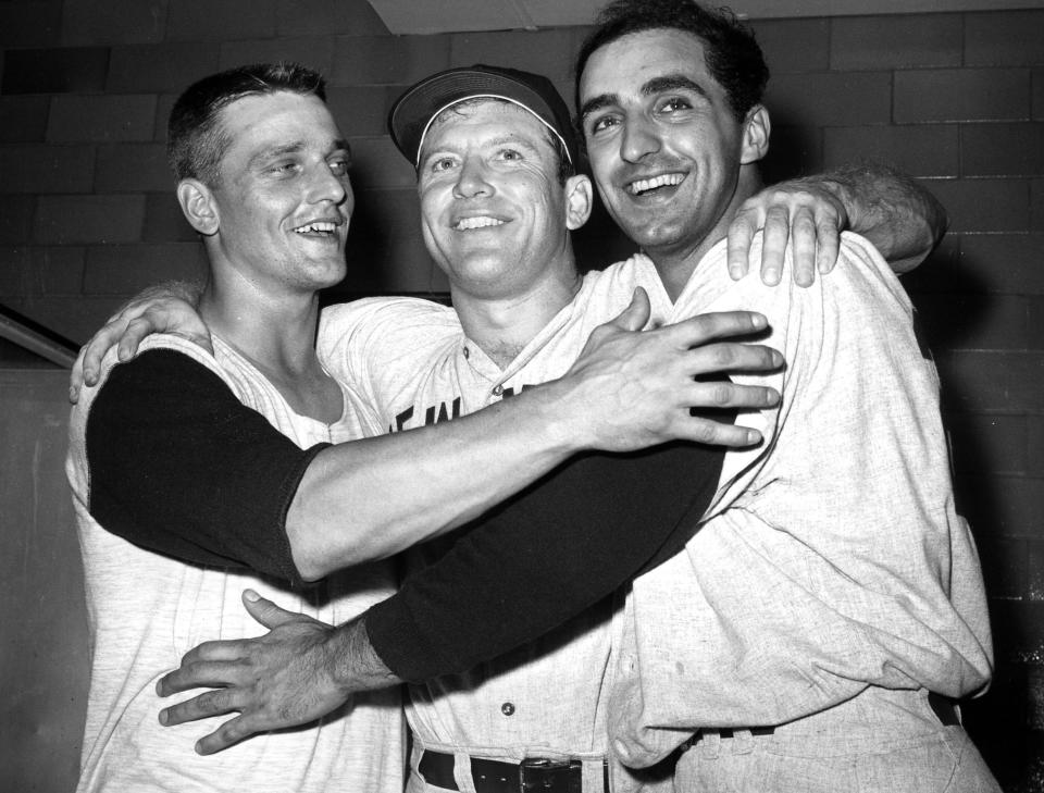 FILE - From left to right, New York Yankees' Roger Maris, Mickey Mantle and Joe Pepitone pose for a photo after their 8-3 win over the St. Louis Cardinals, Oct. 14, 1964, in the sixth baseball game of the World Series in St. Louis. Pepitone, a key figure on the 1960s Yankees who gained reknown for his flamboyant personality, has died at age 82. He was living with his daughter Cara Pepitone at her house in Kansas City, Mo., and was found dead Monday, March 13, 2023, according to BJ Pepitone, a son of the former player. (AP Photo/File)