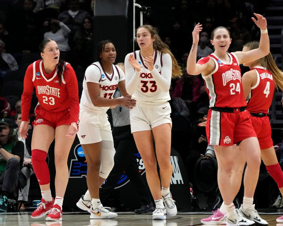 March 27, 2023; Seattle, WA, USA; Virginia Tech Hokies forward Taylor Soule (13) and Virginia Tech Hokies center Elizabeth Kitley (33) celebrate after a foul was called on Ohio State Buckeyes forward Rebeka Mikulasikova (23) during the second half of an NCAA Tournament Elite Eight basketball game at Climate Pledge Arena in Seattle on Monday. Mandatory Credit: Barbara J. Perenic/Columbus Dispatch