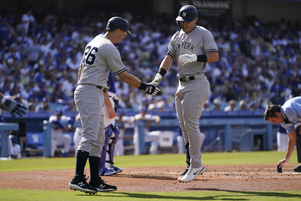 New York Yankees' Jake Bauers (61) celebrates with DJ LeMahieu (26) after they both scored off of a home run hit by Bauers during the second inning of a baseball game against the Los Angeles Dodgers in Los Angeles, Saturday, June 3, 2023. (AP Photo/Ashley Landis)