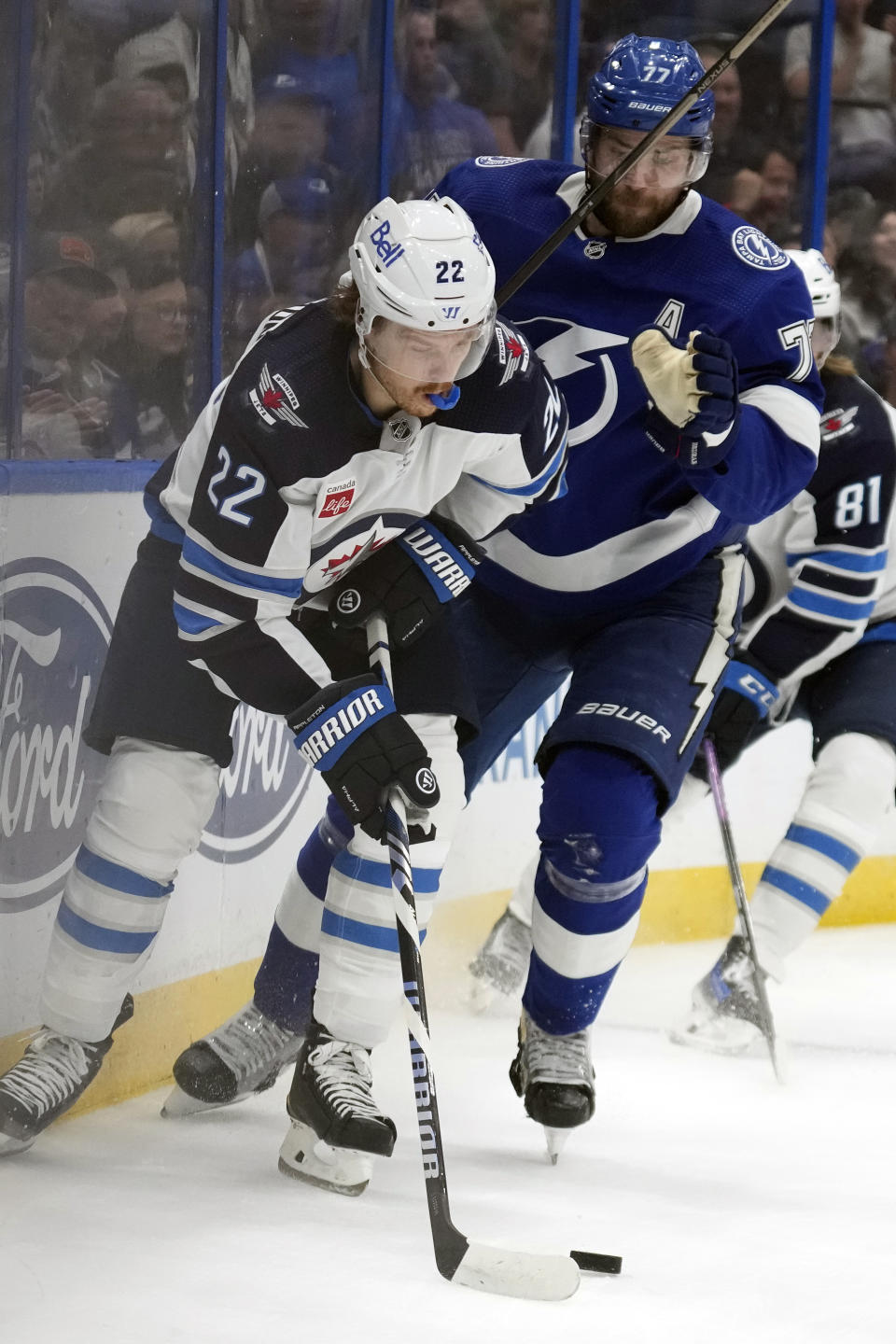 Winnipeg Jets center Mason Appleton (22) moves the puck in front ofTampa Bay Lightning defenseman Victor Hedman (77) during the first period of an NHL hockey game Wednesday, Nov. 22, 2023, in Tampa, Fla. (AP Photo/Chris O'Meara)