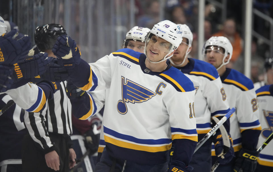 St. Louis Blues center Brayden Schenn is congratulated for his goal against the Colorado Avalanche during the third period of an NHL hockey game Saturday, Nov. 11, 2023, in Denver. (AP Photo/David Zalubowski)