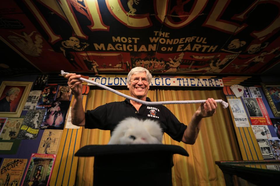 Abbott Magic Co. owner Greg Bordner poses for a photo in the Grand Magic Theater on Thursday, Aug. 8, 2013, in his store located in the village of Colon.