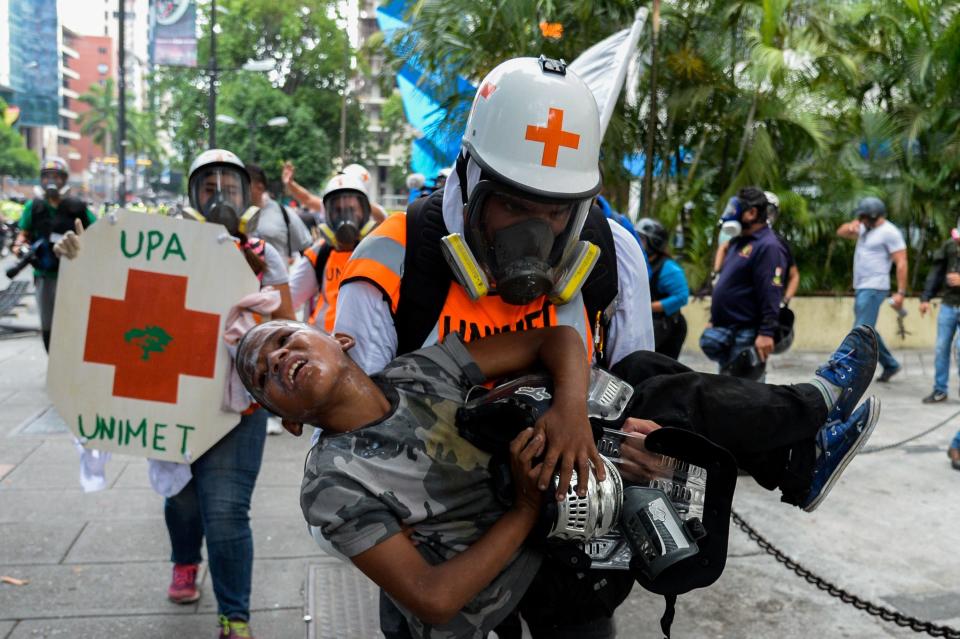 Medical staff carry a boy suffering from the effects of tear gas on May 30.