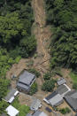 This aerial view shows the site of a mudslide caused by heavy rain in Ashikita town, Kumamoto prefecture, southwestern Japan, Saturday, July 4, 2020. Heavy rain triggered flooding and mudslides on Saturday, leaving more than a dozen missing and others stranded on rooftops waiting to be rescued, officials said. More than 75,000 residents in the prefectures of Kumamoto and Kagoshima were asked to evacuate following pounding rains overnight. (Kyodo News via AP)