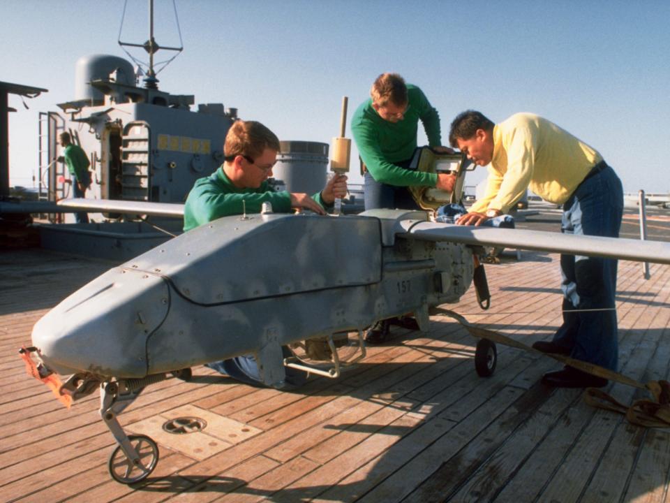 Crew members aboard the battleship USS Wisconsin prepare a Pioneer remotely piloted vehicle for launch during the Gulf War.