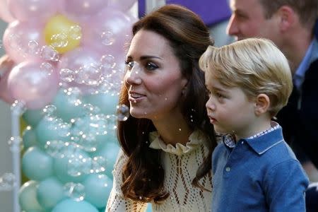 Britain's Catherine, Duchess of Cambridge, and Prince George look at bubbles at a children's party at Government House in Victoria, British Columbia, Canada, September 29, 2016. REUTERS/Chris Wattie