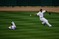 DETROIT, MI - OCTOBER 13: Austin Jackson #14 fields the ball as Ryan Raburn #25 of the Detroit Tigers fails to make a catch on a hit by David Murphy #7 of the Texas Rangers in the sixth inning of Game Five of the American League Championship Series at Comerica Park on October 13, 2011 in Detroit, Michigan. (Photo by Kevork Djansezian/Getty Images)