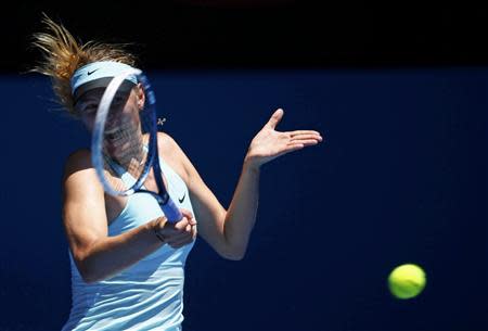 Maria Sharapova of Russia hits a return to Karin Knapp of Italy during their women's singles match at the Australian Open 2014 tennis tournament in Melbourne January 16, 2014. REUTERS/David Gray