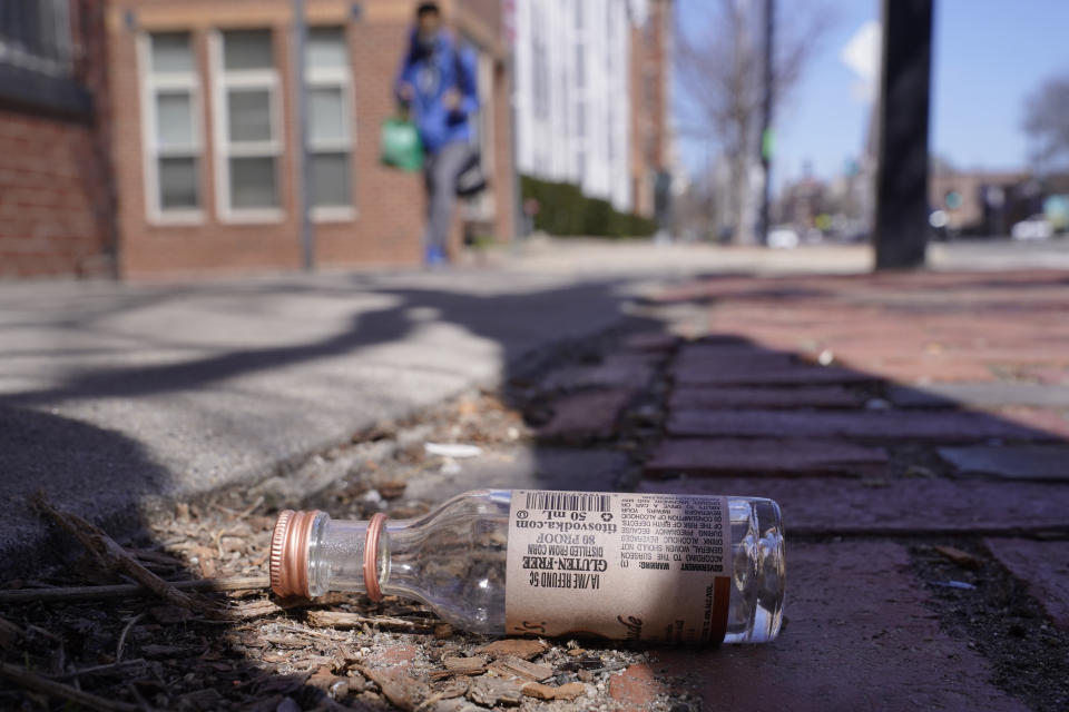 An empty miniature bottle that once contained vodka rests on a sidewalk, Monday, April 3, 2023, in Boston. A Boston city councilor has proposed barring city liquor stores from selling the single-serve bottles that hold 100 milliliters or less of booze both as a way to address alcohol abuse and excessive litter. (AP Photo/Steven Senne)