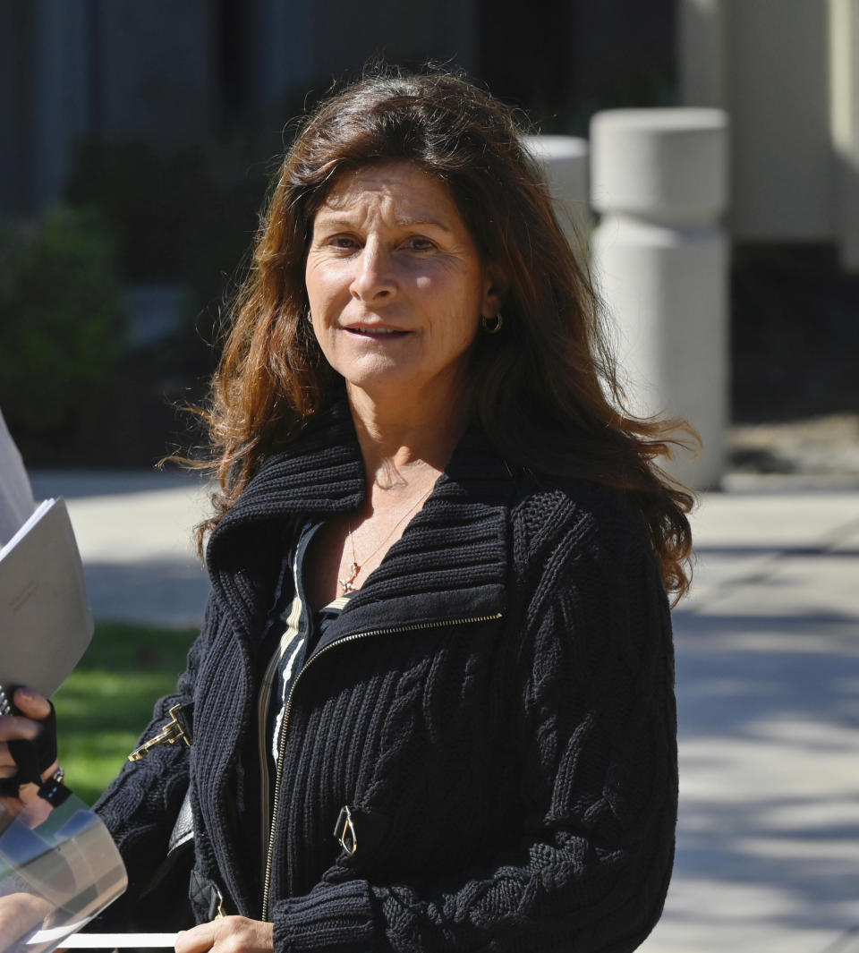 Marianne Campbell Smith is greeted by supporters as she leaves the West Justice Center, Wednesday, Oct. 20, 2021, in Westminster, Calif., during a lunch break in her trial. Smith, who refused to leave a Costa Mesa grocery store, was convicted of trespassing on Wednesday after becoming the only person to go on trial in Orange County for not following pandemic-driven face-covering mandates at local businesses. (Jeff Gritchen/The Orange County Register via AP)