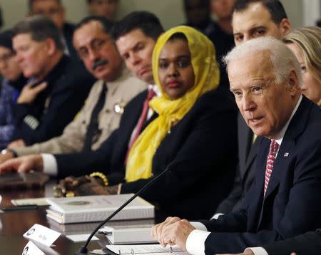 U.S. Vice President Joe Biden (R) attends a roundtable on countering violent extremism at the White House in Washington February 17, 2015. REUTERS/Gary Cameron