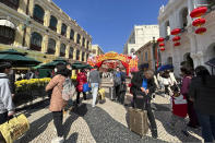 Travelers from mainland China walk around Senado Square, a tourist destination in Macao, Wednesday, Jan. 18, 2022. A hoped for boom in Chinese tourism over next week's Lunar New Year holidays looks set to be more of a blip as most travelers avoid traveling overseas, if at all. (AP Photo/Kanis Leung)