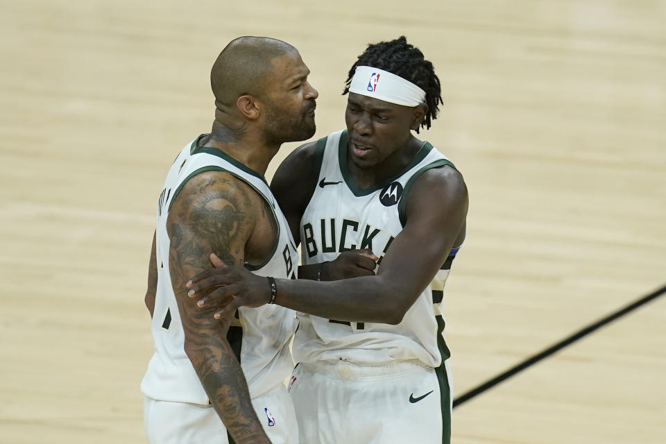 Milwaukee Bucks forward P.J. Tucker, left, celebrates with guard Jrue Holiday during the second half of Game 5 of basketball's NBA Finals against the Phoenix Suns, Saturday, July 17, 2021, in Phoenix. (AP Photo/Ross D. Franklin)