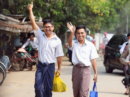 Reuters reporters Wa Lone and Kyaw Soe Oo gesture as they walk free outside Insein prison after receiving a presidential pardon in Yangon, Myanmar, May 7, 2019. REUTERS/Ann Wang