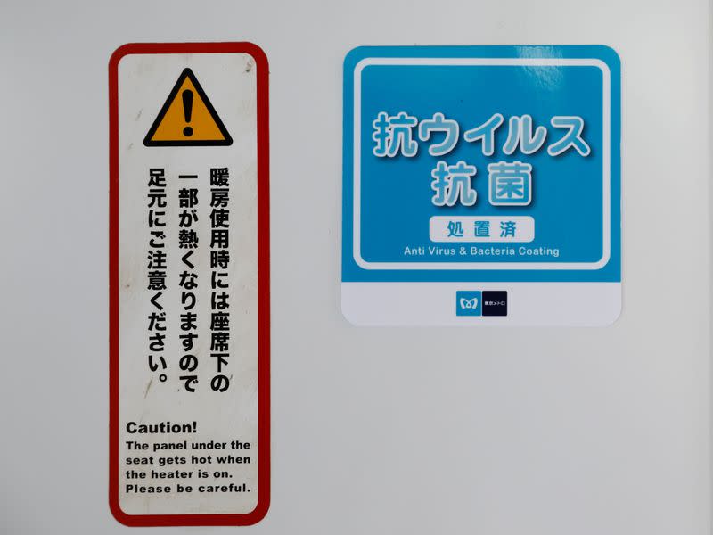 A sticker informing passengers about the task of anti-virus and bacteria coating procedure are displayed inside a railway car in Tokyo