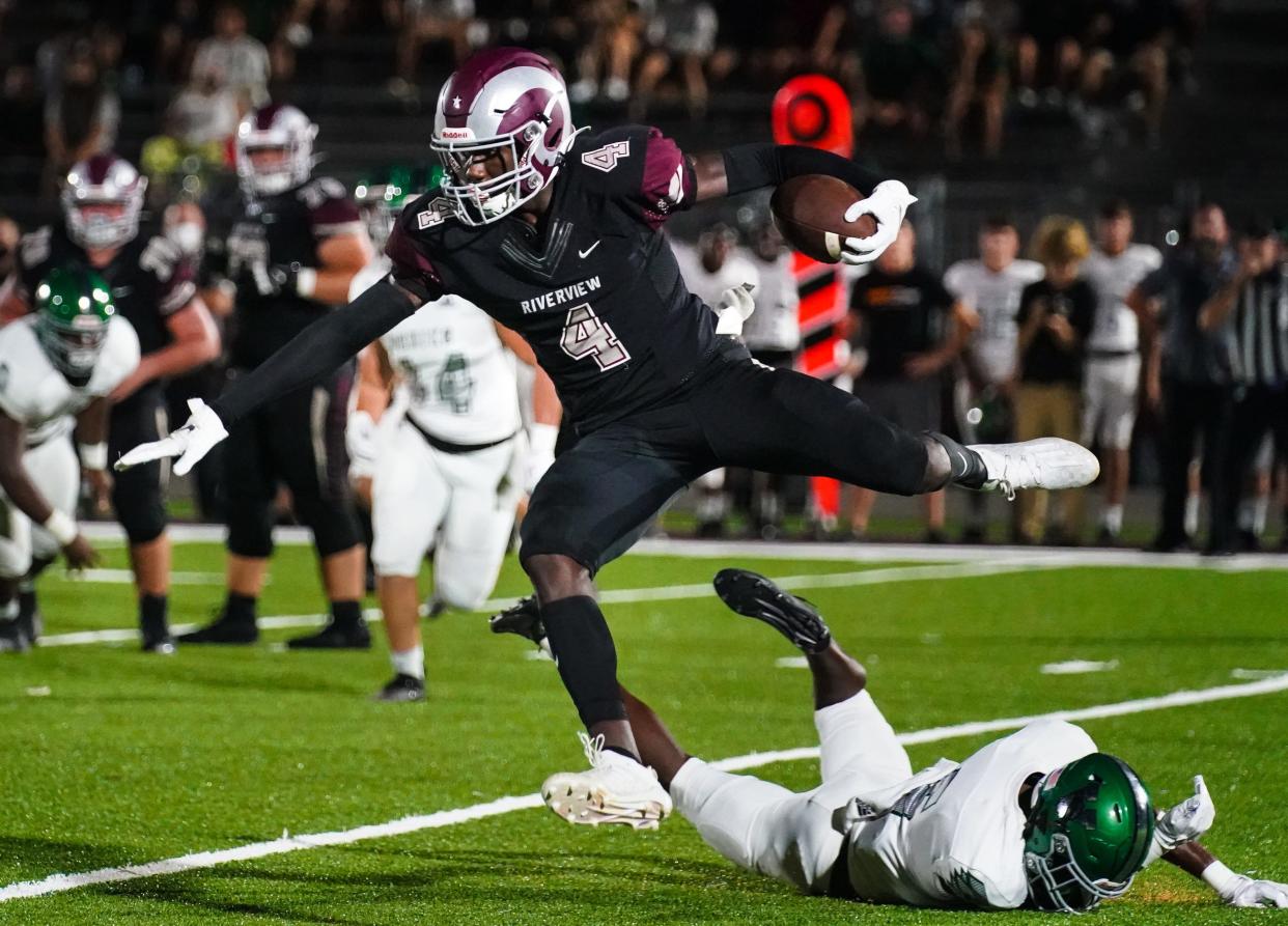 Riverview High's Jaron Glover leaps over a Venice defender during Friday night's game in Sarasota.