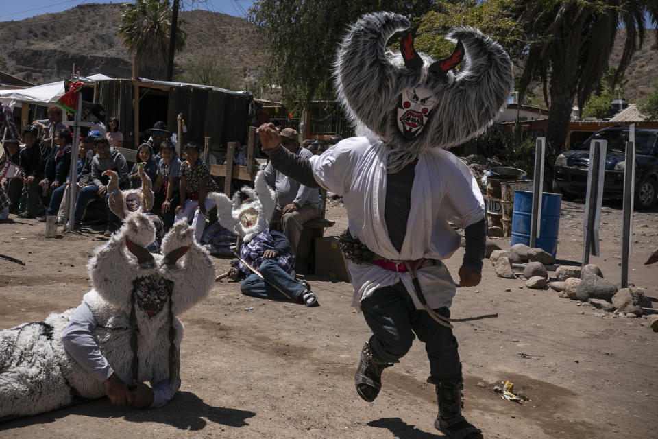 Villagers wearing costumes take part in a Holy Thursday celebration in Santa Rosalia, in the municipality of Mulege, Baja California Sur state, Mexico, Thursday, April 6, 2023. (AP Photo/Emilio Espejel)