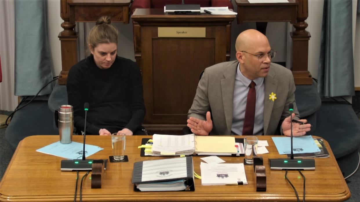 Liberal MLA Gord McNeilly, right, sits beside Kristen Cameron in the P.E.I. Legislature on Tuesday, as MLAs debated his private members bill on alcohol use education. Cameron was partially paralyzed by a drunk driver in 2010. (Submitted by Government of P.E.I. - image credit)