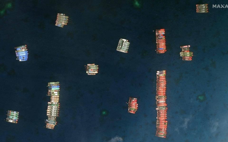 Chinese vessels anchored at the disputed Whitsun Reef in the South China Sea - AFP PHOTO / Satellite image/ Maxar Technologies