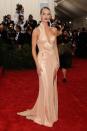 <p>Rosie Huntington-Whiteley shut down the red carpet in 2015 with the sculptural champagne-coloured Versace gown.</p>