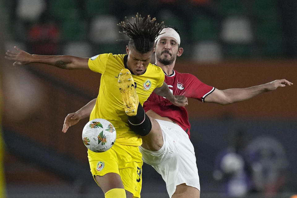 Mozambique's Lau King, left vies for the ball with Egypt's Ahmed Hegazi during the African Cup of Nations Group B soccer match between Egypt and Mozambique in Abidjan, Ivory Coast, Sunday, Jan. 14, 2024. (AP Photo/Themba Hadebe)