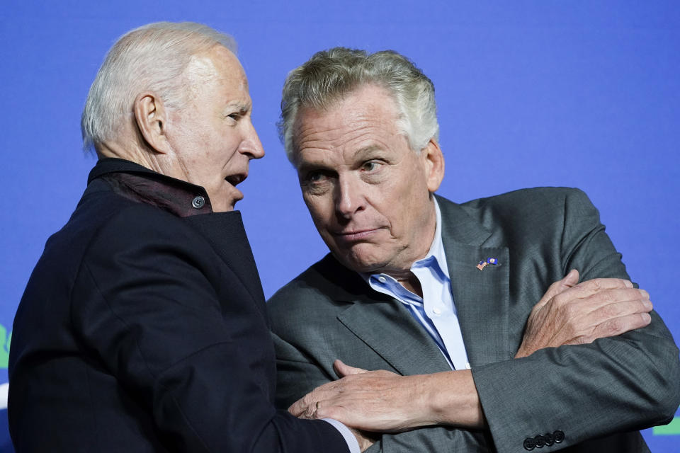 President Joe Biden speaks with Democratic gubernatorial candidate, former Virginia Gov. Terry McAuliffe during a rally Tuesday, Oct. 26, 2021, in Arlington, Va. McAuliffe will face Republican Glenn Youngkin in the November election. (AP Photo/Alex Brandon)