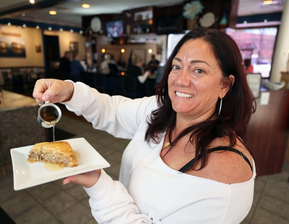 Mediterranean Bar & Grill co-owner Maria Dimakis shows off some homemade baklava on Thursday, April 25, 2024, at the Taunton restaurant.
