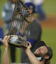 Los Angeles Dodgers pitcher Clayton Kershaw celebrates with the trophy after defeating the Tampa Bay Rays 3-1 to win the baseball World Series in Game 6 Tuesday, Oct. 27, 2020, in Arlington, Texas. (AP Photo/Eric Gay)