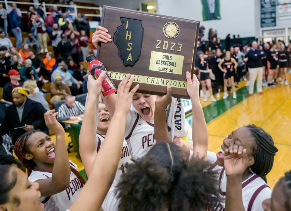 The Peoria High Lions raise their Class 3A sectional title plaque after defeating Washington 35-29 in the title game Thursday, Feb. 23, 2023 at Richwoods High School. The Lions will face Chicago Marian at 7:30 p.m. Monday in the Pontiac supersectional for a berth in the state finals.