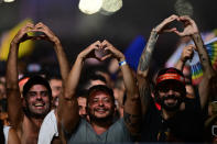 Fans hold up their hands in the shape of hearts as US pop star Madonna performs during a free concert at Copacabana beach in Rio de Janeiro, Brazil, on May 4, 2024. . Madonna ended her "The Celebration Tour" with a performance attended by some 1.5 million enthusiastic fans. (Photo by Pablo PORCIUNCULA / AFP) (Photo by PABLO PORCIUNCULA/AFP via Getty Images)