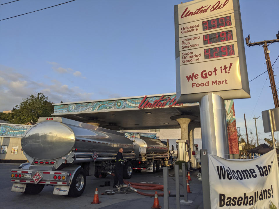 In this Friday, May 20, 2021, photo, a fuel truck driver checks the gasoline tank level at a United Oil gas station in Sunset Blvd., in Los Angeles. The average U.S. price of regular-grade gasoline jumped 8 cents over the past two weeks, to $3.10 per gallon. Industry analyst Trilby Lundberg of the Lundberg Survey said Sunday, May 23, that the increase is attributed to supply disruption from the 10-day shutdown of the Colonial Pipeline following a cyberattack, and a rise in prices for corn, a key ingredient in corn-based ethanol that must be blended by refiners into gasoline. (AP Photo/Damian Dovarganes)