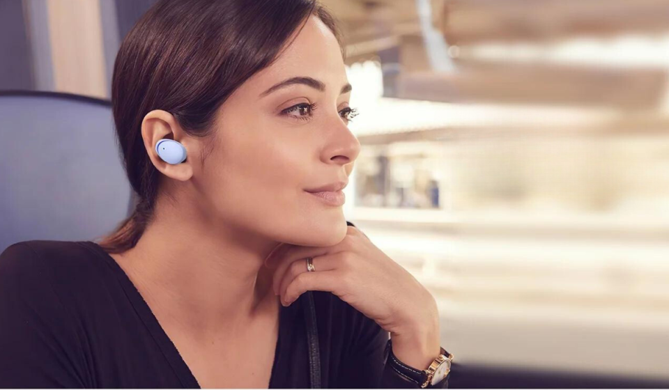 woman listening to music in earbuds on public transportation