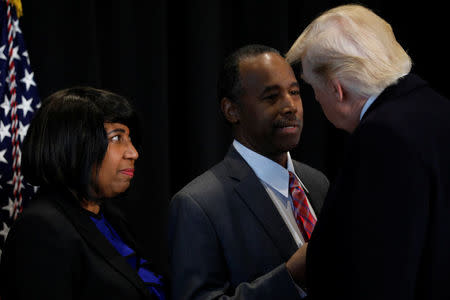 U.S. President Donald Trump (R) speaks with Ben Carson, his nominee to lead the Department of Housing and Urban Development (HUD), after their visit to the National Museum of African American History and Culture on the National Mall in Washington, U.S. February 21, 2017. Also pictured is Carson's wife, Candy Carson (L). REUTERS/Jonathan Ernst