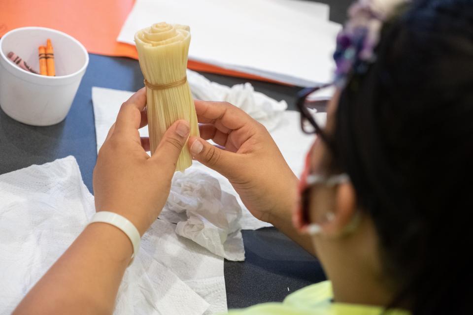 Students made cornhusk flowers Tuesday at the First Nations Achievement Summit at UW-Green Bay.