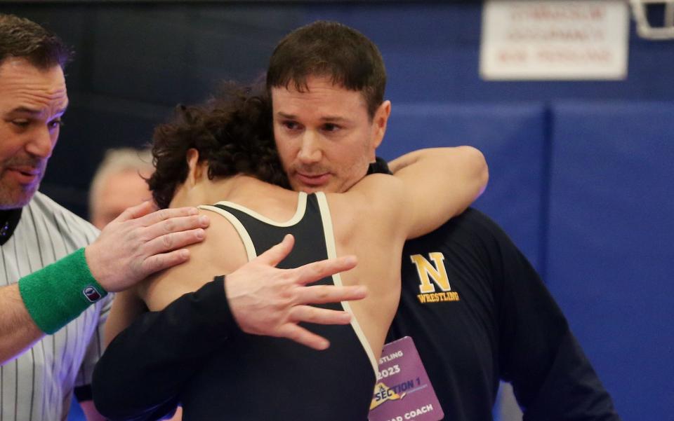 Nanuet coach Sean Conklin hugs Ethan Badillo after his Section 1 Division II 118-pound championship victory at the 2023 Section 1 small-school division sectional championships at Hen Hud.