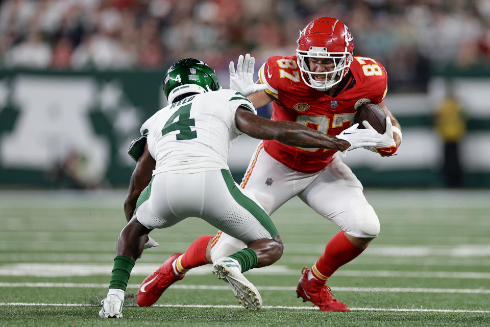 Kansas City Chiefs tight end Travis Kelce (87) carries the ball against *New York Jets cornerback D.J. Reed (4) during the fourth quarter of an NFL football game, Sunday, Oct. 1, 2023, in East Rutherford, N.J. (AP Photo/Adam Hunger)