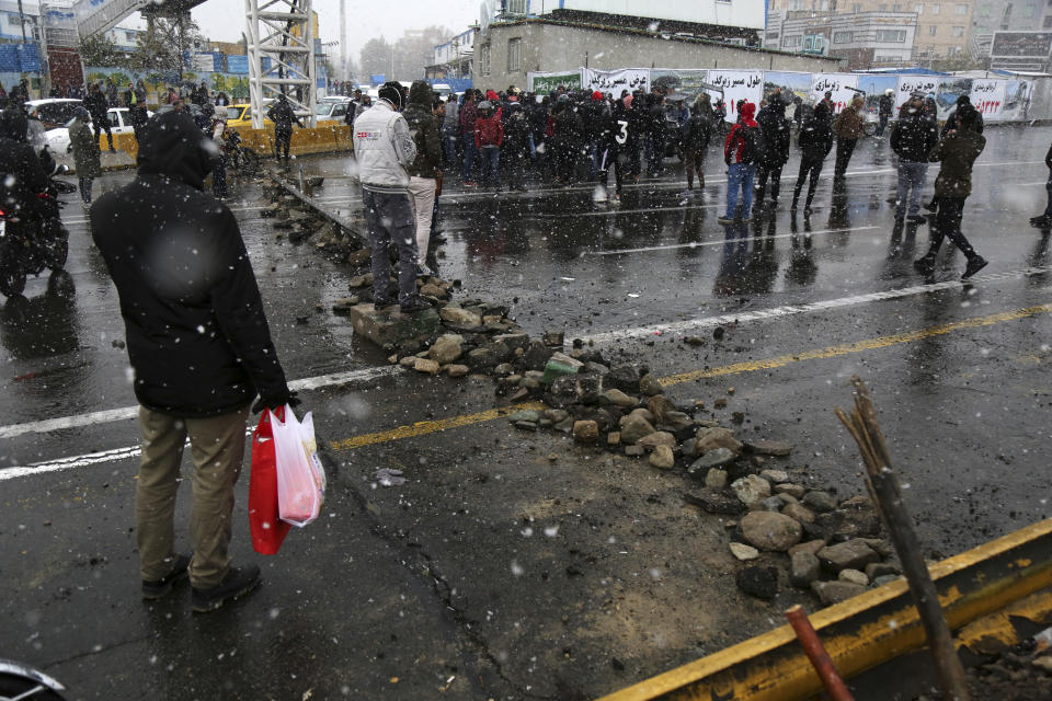 A road is blocked by protestors after authorities raised gasoline prices, in Tehran, Iran, Saturday, Nov. 16, 2019. Protesters angered by Iran raising government-set gasoline prices by 50% blocked traffic in major cities and occasionally clashed with police Saturday after a night of demonstrations punctuated by gunfire. (Majid Khahi/ISNA via AP)