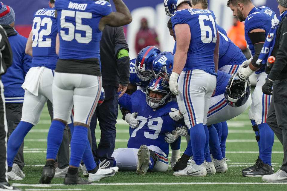 New York Giants offensive tackle Tyre Phillips (79) reacts after an apparent injurt during the second half an NFL football game against the Los Angeles Rams, Sunday, Dec. 31, 2023, in East Rutherford, N.J. (AP Photo/Seth Wenig)