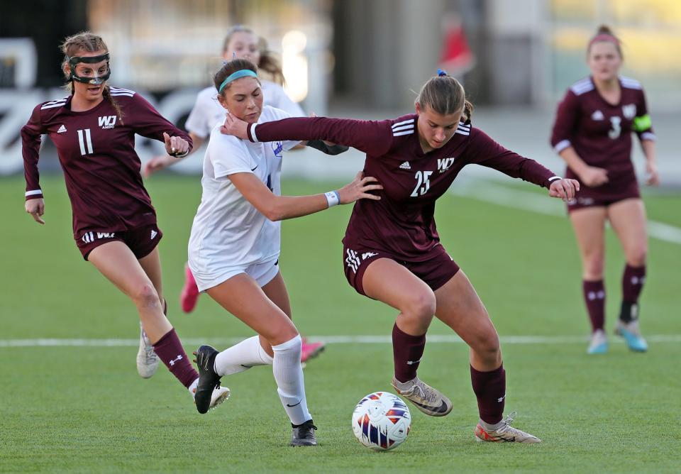 Walsh Jesuit's Abby Witkiewicz, right, battles for the ball with Olentangy Liberty's Ava Petrucci during the first half of the OHSAA Division I girls state soccer championship game Friday in Columbus.